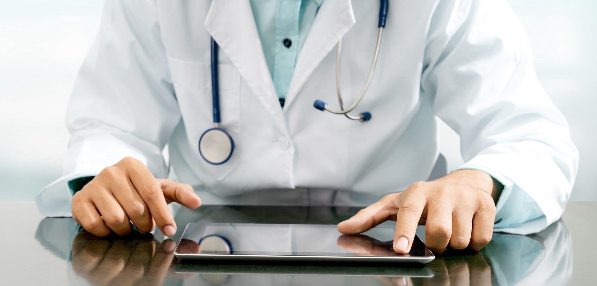 a doctor working on an iPad